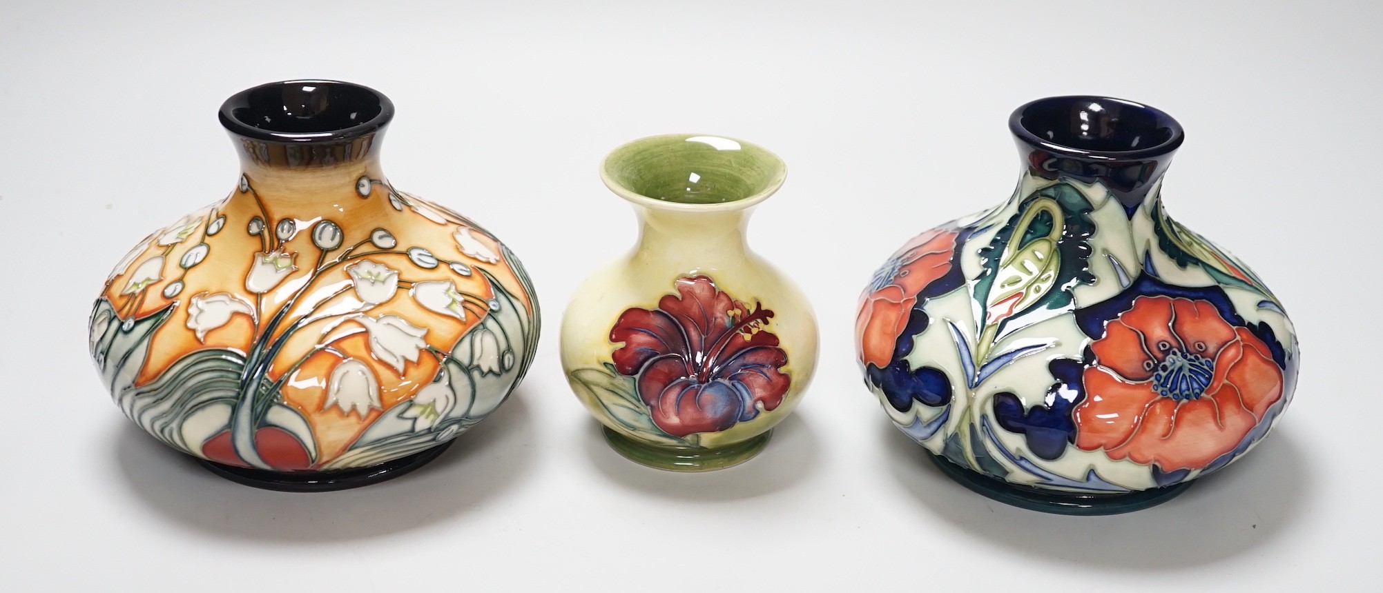 Three Moorcroft vases, in Poppy, Hibiscus and Tulip designs, tallest 10.5 cm, one boxed